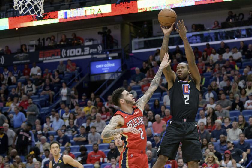 Los Angeles Clippers forward Kawhi Leonard (2) shoots against New Orleans Pelicans guard Lonzo Ball (2) in the first half an NBA basketball game in New Orleans, Saturday, Jan. 18, 2020. (AP Photo/Matthew Hinton)