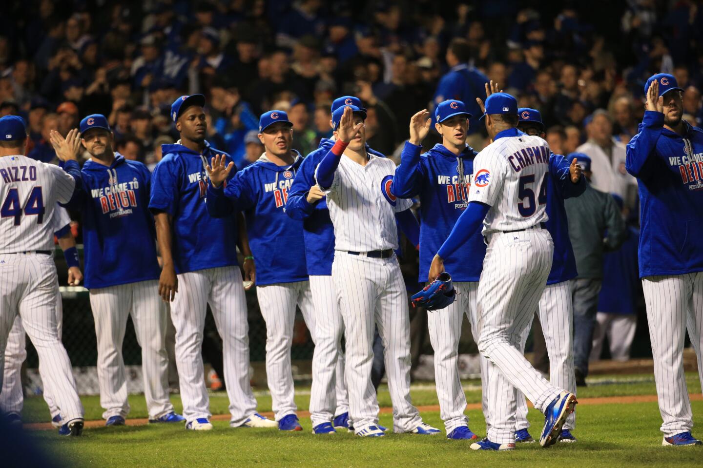 The Cubs celebrate their win against the Giants in Game 1 of the National League Division Series at Wrigley Field.