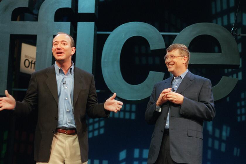 Jeff Bezos, founder and CEO of Amazon.com, left, meets with Bill Gates, Microsoft Corp. chairman and chief software architect, at a New York news conference to launch Microsoft's new software, Office XP, Thursday, May 31, 2001. Gates said Office XP will improve worker productivity, but he acknowledged that there was room for improvement to the product. (AP Photo/Marty Lederhandler) ORG XMIT: NYR102