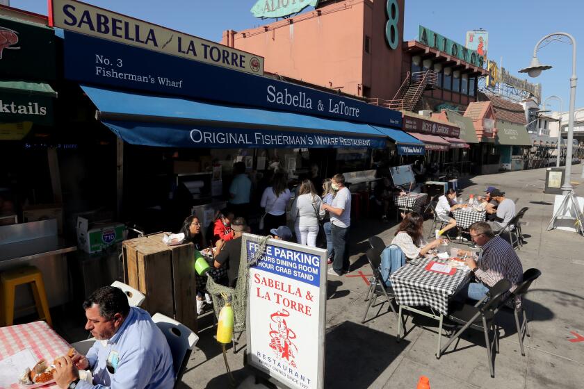 SAN FRANCISCO CA - OCT. 23, 2020. Customers dine in outdoor eating areas at Fishermen's Wharf in San Francisco on Friday, Aug. 23, 2020. San Francisco has done an excellent job following public health guidance and made a huge leap from the coronavirus orange tier to the less restrictive yellow tier, providing a pathway for more businesses and activities to reopen. (Luis Sinco / Los Angeles Times)