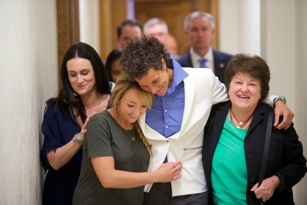 Bill Cosby accuser Andrea Constand, center, and supporters embrace after Cosby was found guilty 