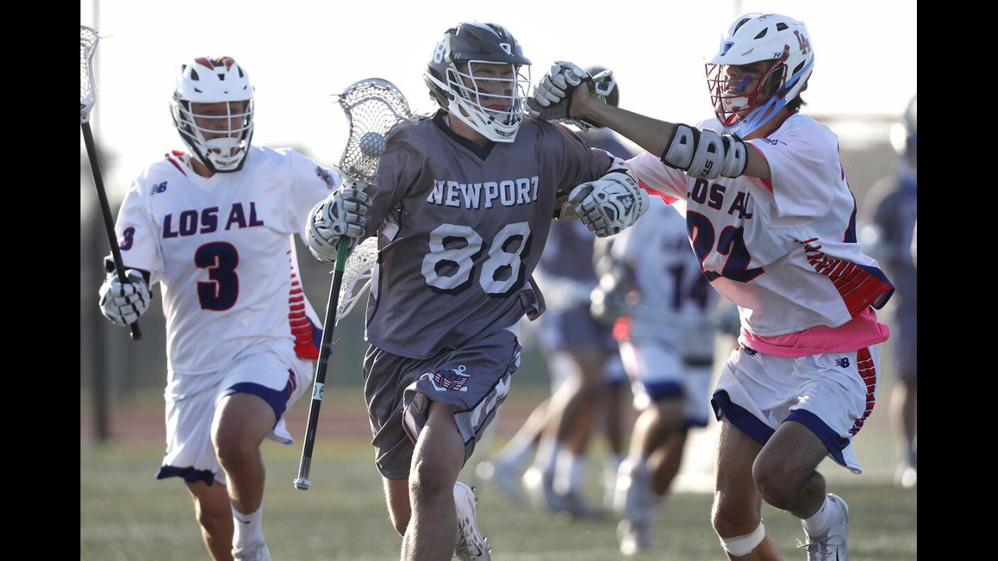 Newport Harbor High's Michael Morrison (88) advances the ball against Los Alamitos during first half in a Sunset League game on Wednesday, April 25.