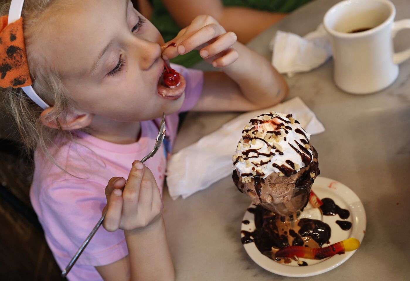 If you're feeling hungry again, or just because, head on over to Fair Oaks Pharmacy, one of the last old-school soda fountains in the Los Angeles area, where Clara Barlow, 6, of Burbank, enjoys a kid-size sundae with a cherry on top.