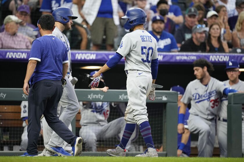 The Dodgers' Mookie Betts (50) leaves the game after doubling during the seventh inning July 17, 2021, in Denver.