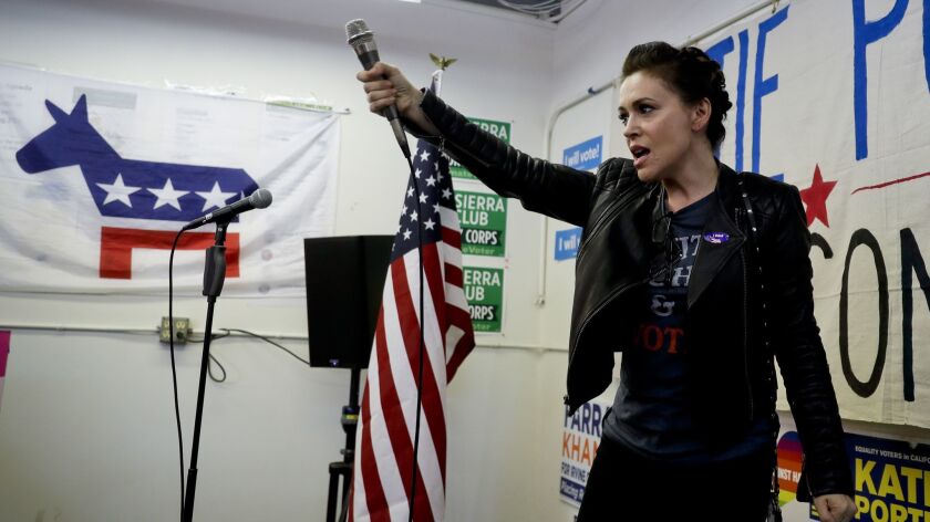Actress Alyssa Milano, shown at a campaign event in Tustin, is among those questioning whether Georgia should be punished for electing a deeply conservative governor rather than Stacey Abrams, who would have been the nation's first black female governor.