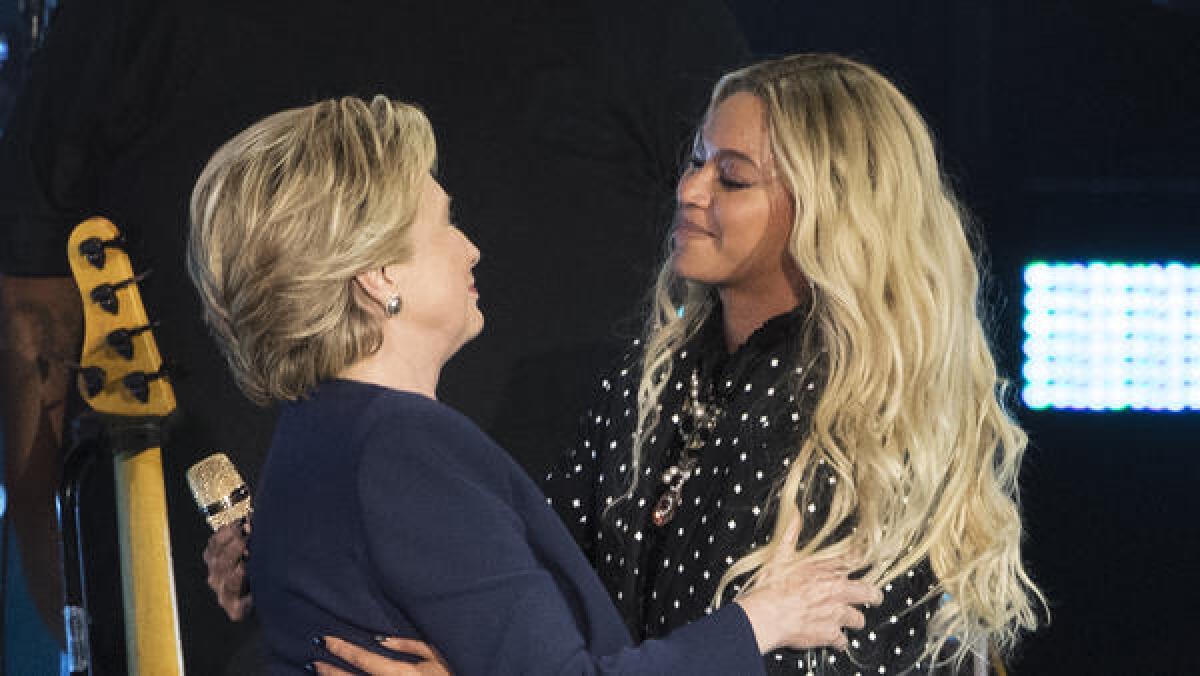 Hillary Clinton and Beyoncé embrace during a campaign rally in Cleveland on Friday.