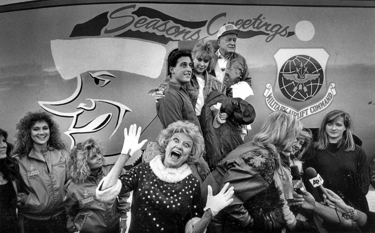 Dec. 21, 1987: Phyllis Diller mugs for the camera during the sendoff for Bob Hope and other entertainers at the Air National Guard base at Van Nuys Airport. The troup, not including Diller, was leaving for an eight-day tour of U.S. military bases.