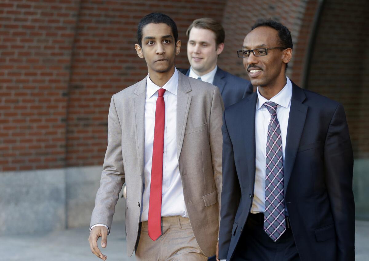 Robel Phillipos, left, a college friend of Boston Marathon bombing suspect Dzhokhar Tsarnaev, departs federal court Monday with defense attorney Derege Demissie, right.