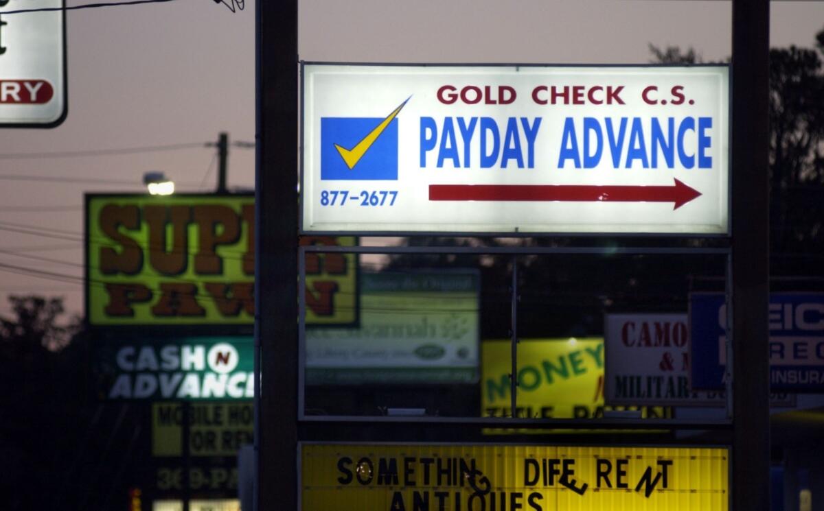 Signs along the road leading to the front gate of Ft. Stewart in Georgia are cluttered with advertisements for easy cash loans targeting soldiers.