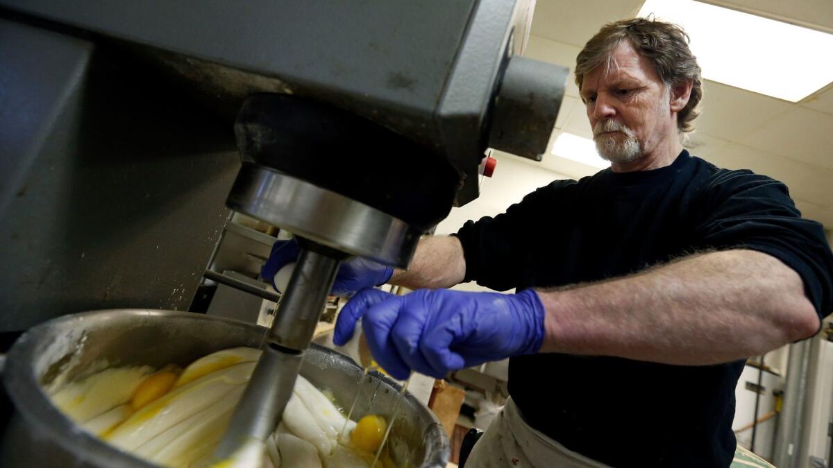 Masterpiece Cakeshop owner Jack Phillips cracks eggs into a cake batter mixer inside his store in Lakewood, Colo. on March 10, 2014.