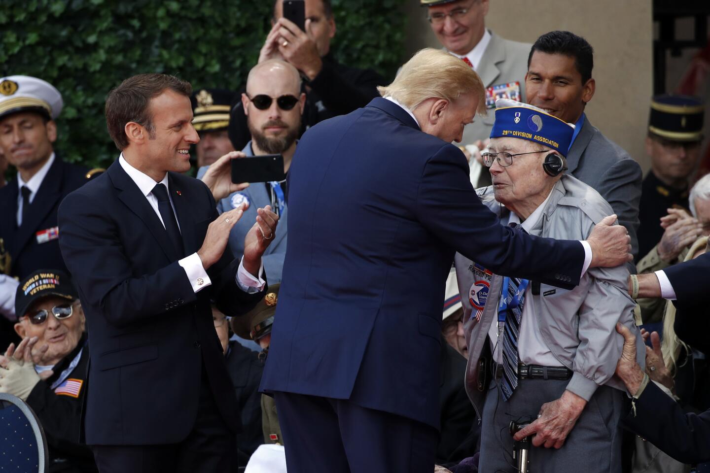 President Trump and French President Emmanuel Macron talk to World War II veterans during a ceremony to commemorate the 75th anniversary of D-day June 6 at the American Normandy cemetery in Colleville-sur-Mer, France.