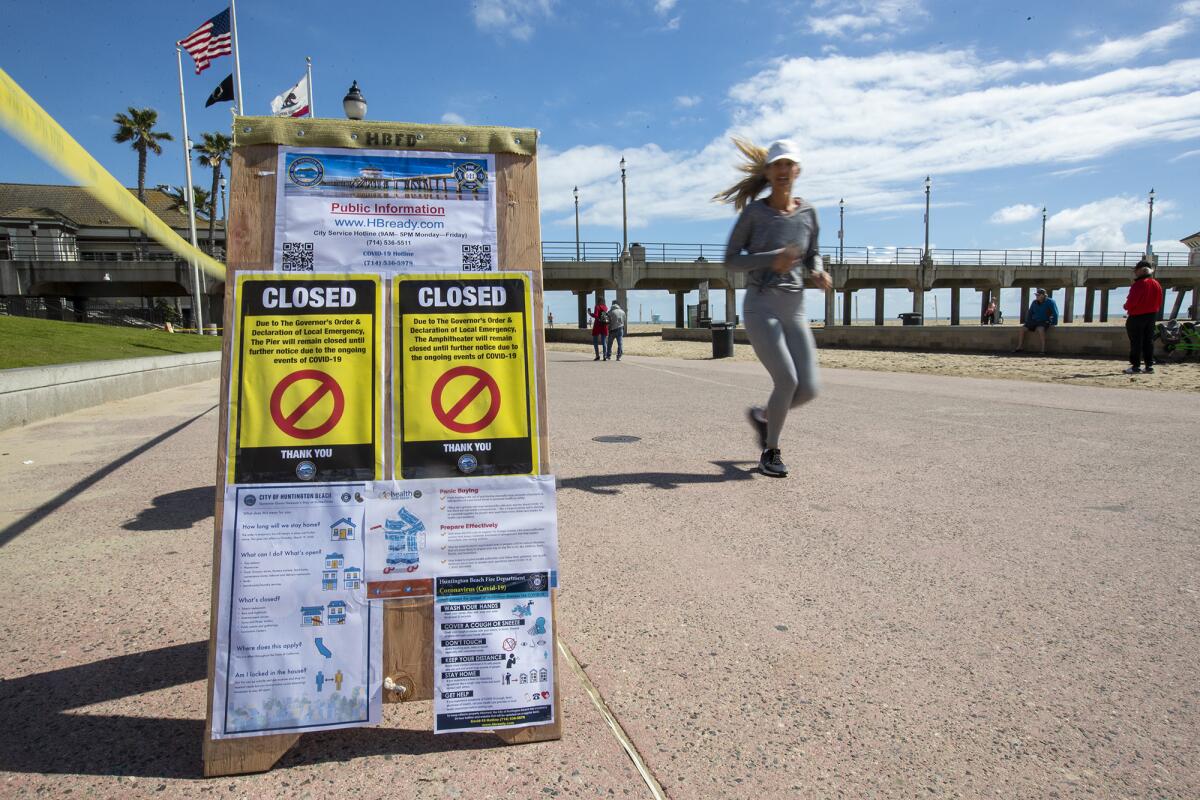 The Huntington Beach Pier closed to the public Tuesday until further notice to prevent close gatherings during the coronavirus outbreak.