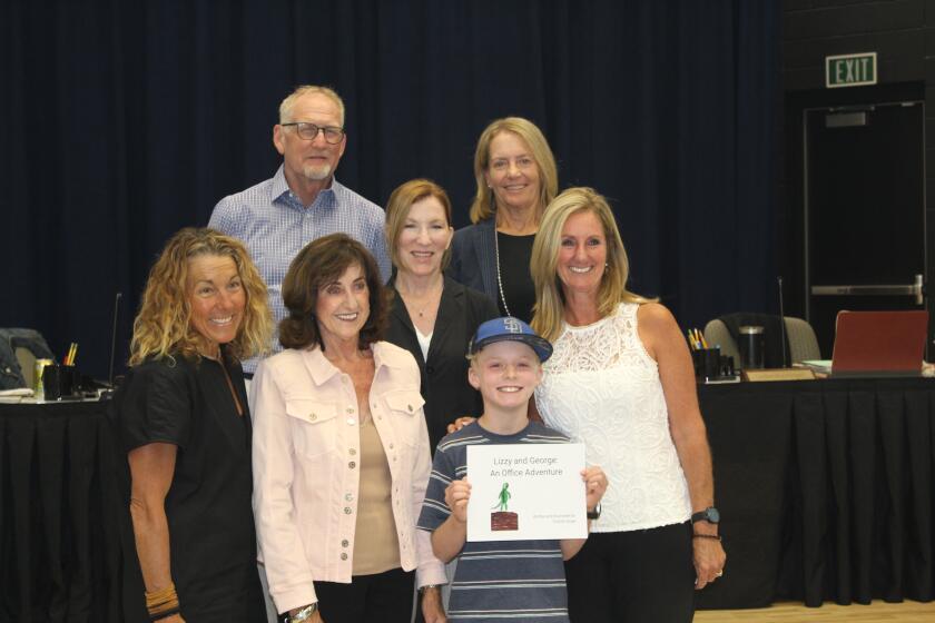 Fifth grade author Charlie Sniger with Solana Beach School District board members, Superintendent Jodee Brentlnger and her mother.