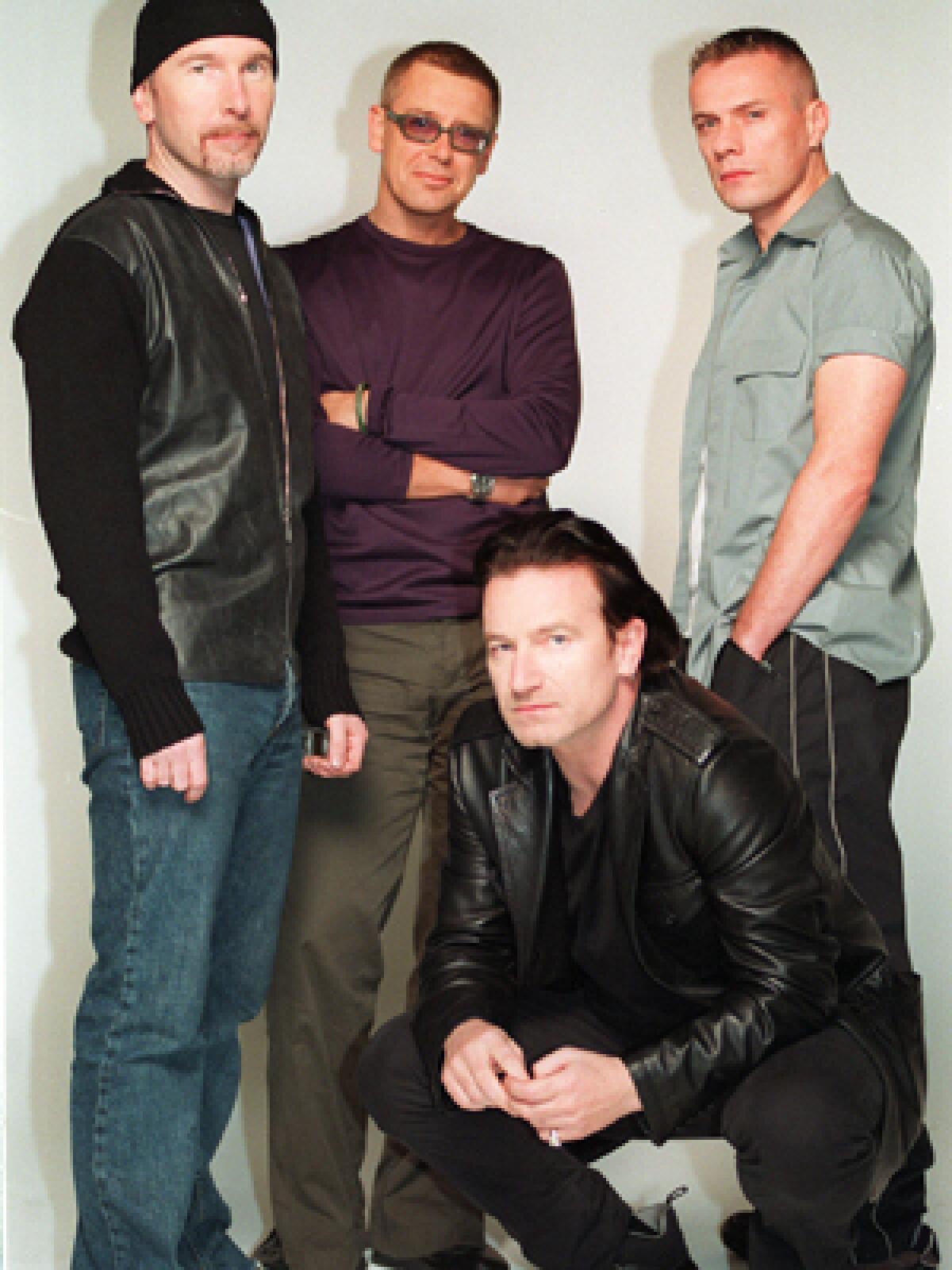 U2 (Bono, kneeling, and Edge, left, Adam Clayton and Larry Mullen in Dublin.