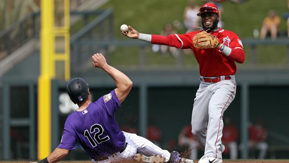 Angels second baseman Luis Rengifo throws to first base after forcing out Colorado Rockies designated hitter Mark Reynolds in the second inning Wednesday.