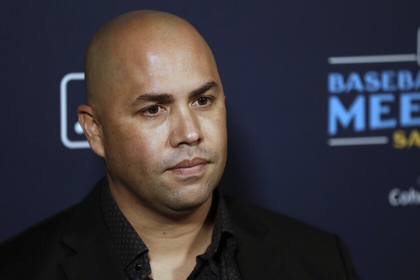 FILE - New York Mets manager Carlos Beltran listens to a question during the Major League Baseball winter meetings, Tuesday, Dec. 10, 2019, in San Diego. With Barry Bonds, Roger Clemens and Curt Schilling off the ballot, next year’s Hall of Fame vote figures to be a bit less contentious. Then again, the top newcomer arrives with his own recent baggage. Carlos Beltrán is eligible for the Hall of Fame in 2023, and although the sweet-swinging outfielder had a distinguished career at the plate and in the field, he was also implicated in the Houston Astros’ sign-stealing scandal. (AP Photo/Gregory Bull, File)