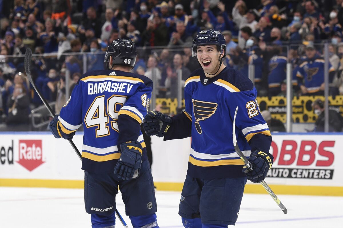 St. Louis Blues center Jordan Kyrou (25) is congratulated by Blues center Ivan Barbashev (49) after scoring the game winning goal over the Dallas Stars during the third period of an NHL hockey game Sunday, Jan. 9, 2022, in St. Louis. (AP Photo/Joe Puetz)