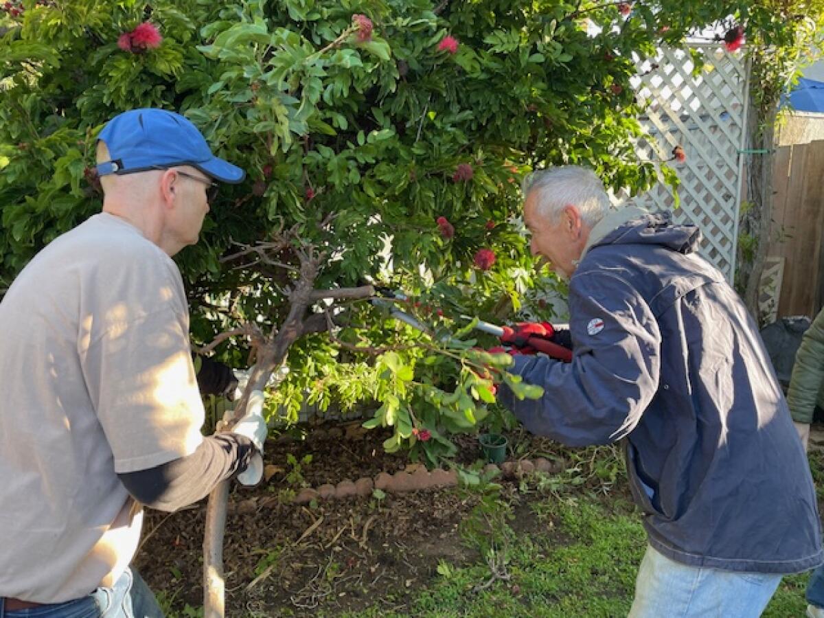 Volunteers with the Labor of Love program help tidy up a home in Costa Mesa.