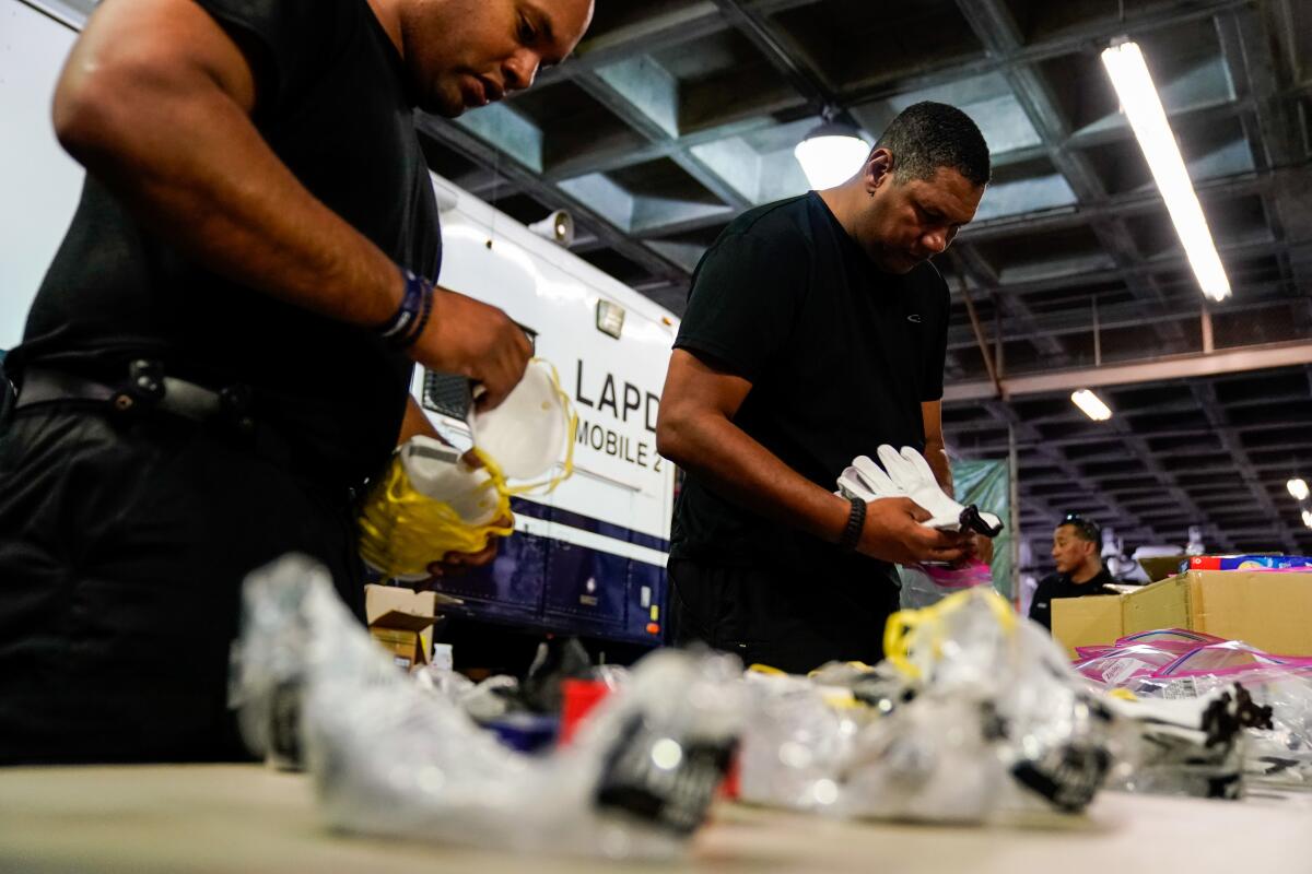 LAPD personnel assemble personal safety kits for field officers earlier this month.