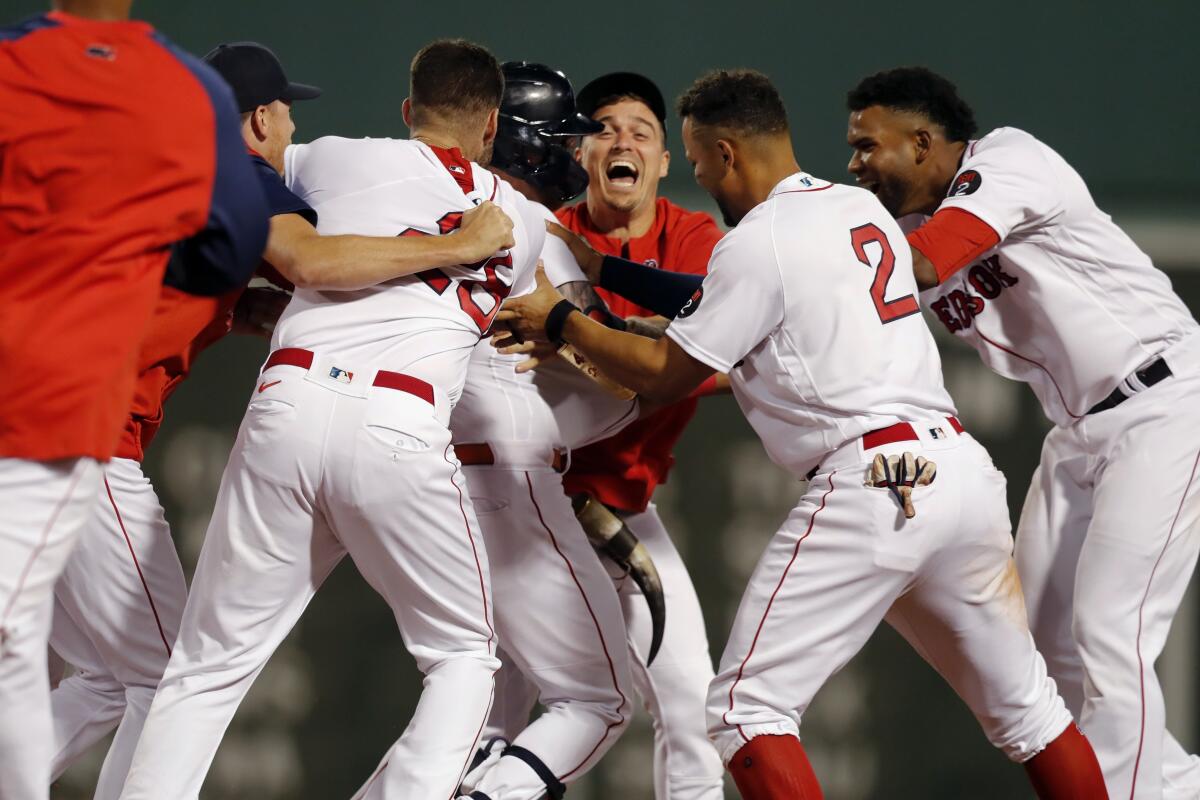 Rafael Devers and Alex Verdugo of the Boston Red Sox celebrate a