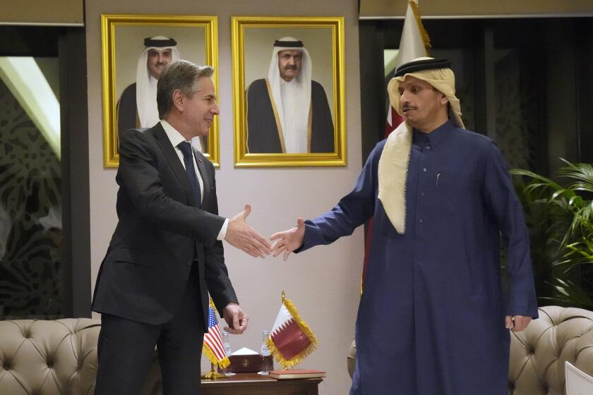 US Secretary of State Antony Blinken, left, shakes hands with Qatar's Prime Minister and Foreign Affairs Minister Mohammed Bin Abdulrahman Al Thani, at Diwan Annex, in Doha, Qatar, Tuesday, Feb. 6, 2024. (AP Photo/Mark Schiefelbein, Pool)