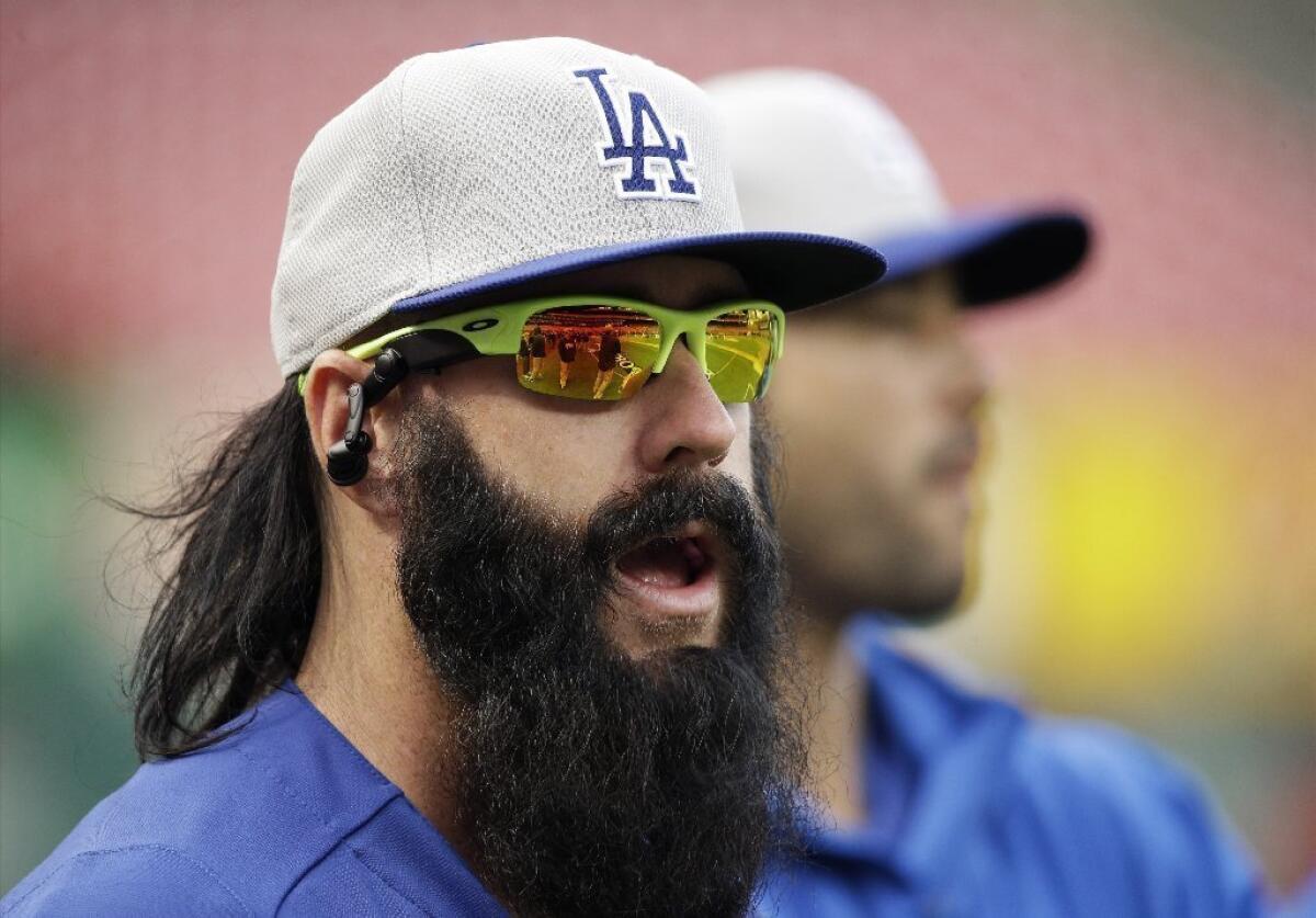 Dodgers relief pitcher Brian Wilson warms up before a game.