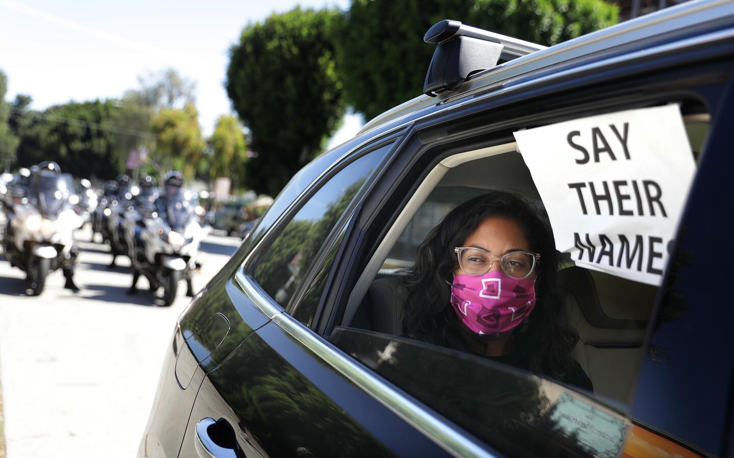 A demonstrator rides in the procession departing Leimert Park for the memorial service.