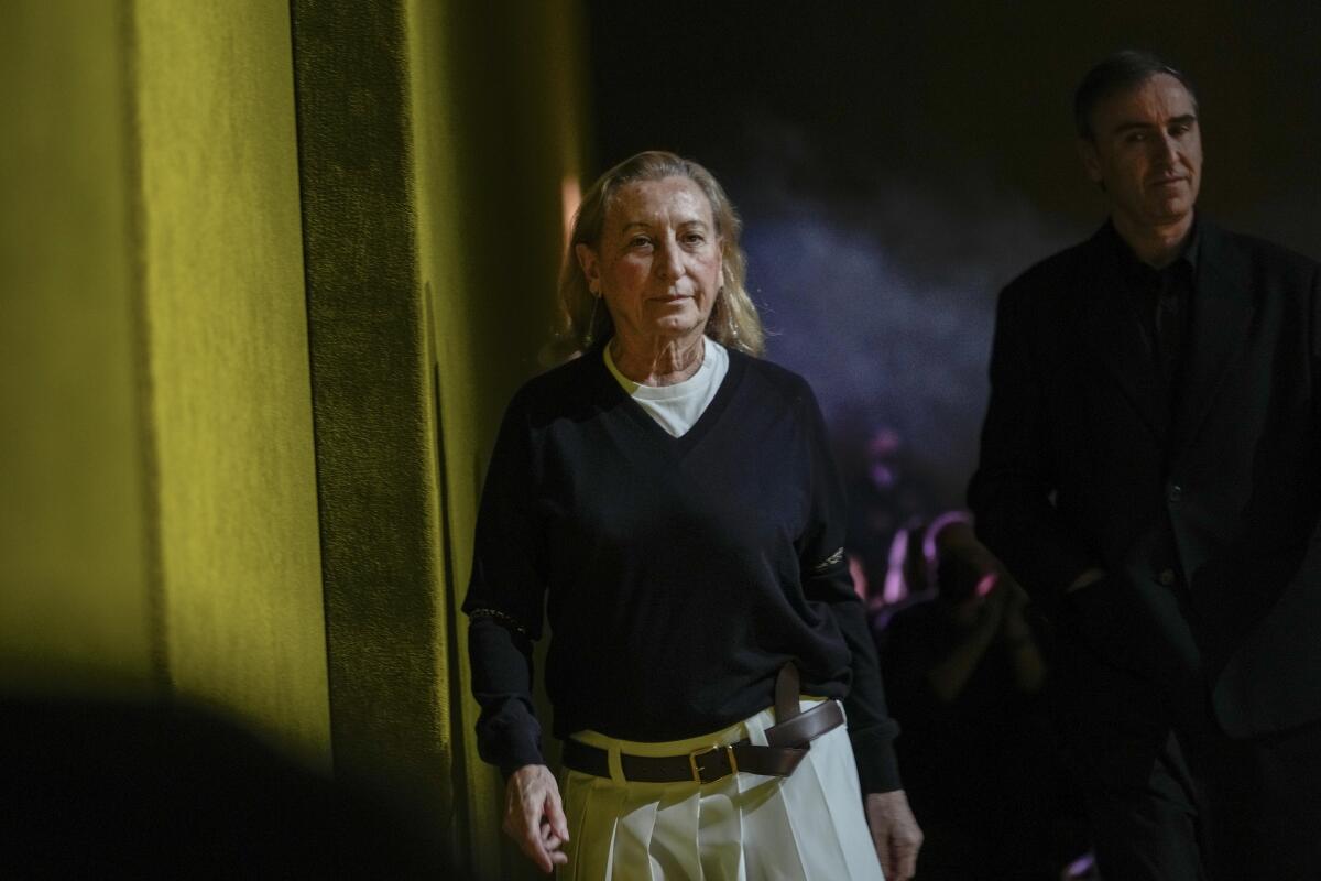 FILE - Miuccia Prada, left, and Raf Simons depart after the Prada Fall/Winter 2022-2023 fashion collection, unveiled during the Fashion Week in Milan, Italy, Thursday, Feb. 24, 2022. The Prada fashion house began charting a line of succession on its business side, announcing Tuesday, Dec. 6, 2022 that it is tapping a former LVMH executive as its next CEO, while confirming that Miuccia Prada will continue in her creative roles. Andrea Guerra is set to be confirmed by the board next month as the new CEO, succeeding Patrizio Bertelli, who will remain on as chairman. (AP Photo/Luca Bruno, file)