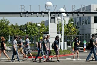 Employees pass in front of the main entrance during walkout to protest the reported sexual harassment and discrimination at Activision Blizzard, in Irvine on Wednesday, July 28, 2021. An organizer who did not want to give her name said that the walkout was "in solidarity with the victims who have stood up, who have made their voices heard. And we are looking to amplify those voices as well as to create a call to action on the demands that we listed." The company statement sent via email to this reporter by employee Christy Um said OWe are fully committed to fostering a safe, inclusive and rewarding environment for all of our employees around the world. We support their right to express their opinions and concerns in a safe and respectful manner, without fear of retaliation. The company does not retaliate for any such decision, should employees choose to participate or not. The company will not require employees to take time off to participate in this walkout.O The walkout began at 10am and continued until 2 pm. Nofurther actions were planned, according to walkout representatives.