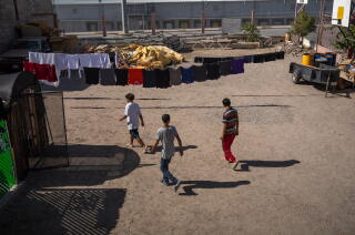Migrants walk in the yard at Albergue Vida