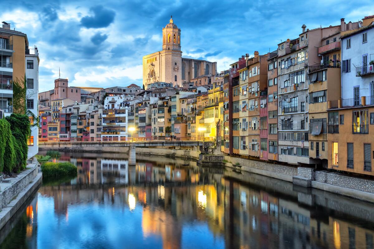 Girona's cathedral and waterfront houses are reflected in the Onyar.
