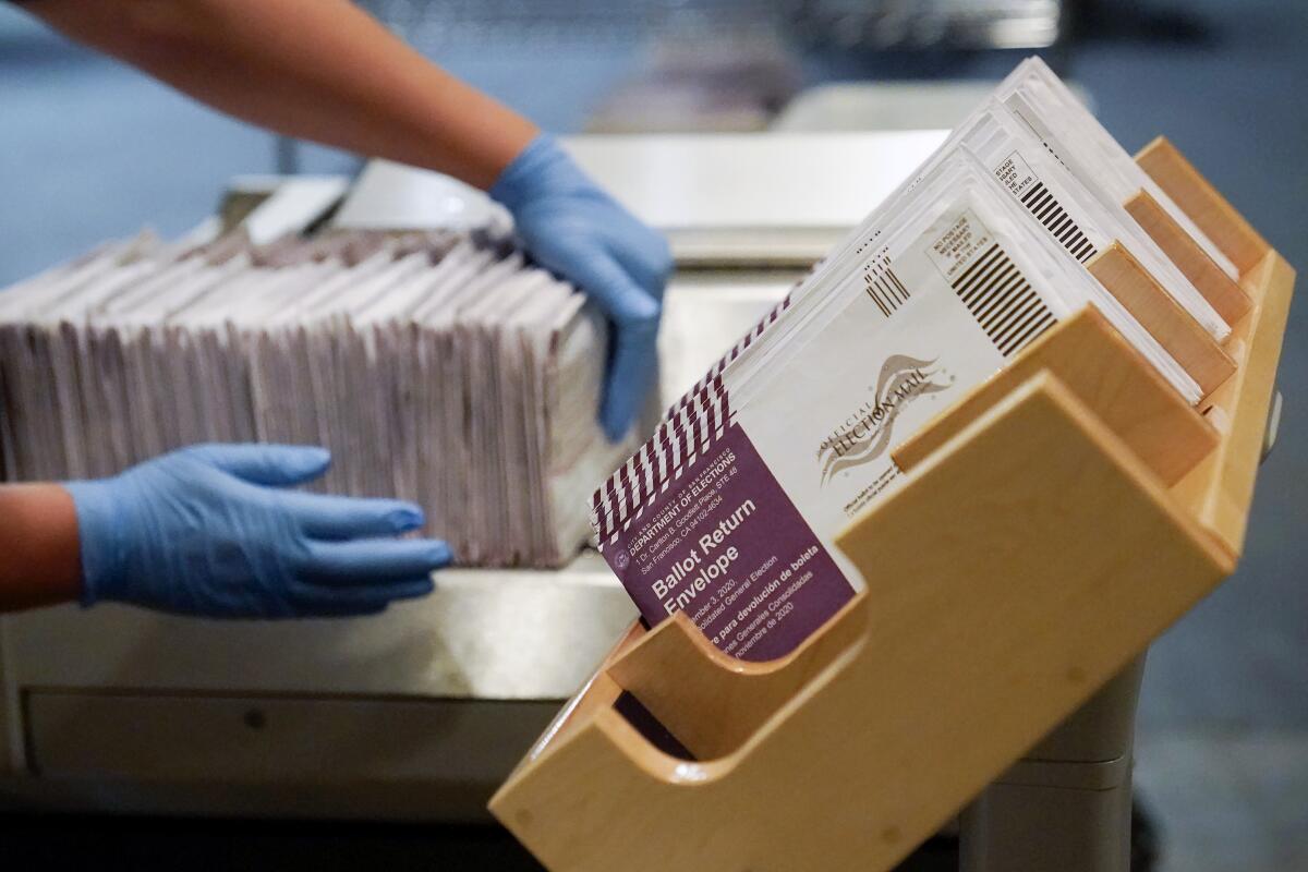 FILE - In this Nov. 1, 2020, file photo, envelopes containing ballots are shown at a San Francisco Department of Elections at a voting center in San Francisco. A new study finds the expansion of mail voting did not benefit Democrats or increase turnout. (AP Photo/Jeff Chiu, File)