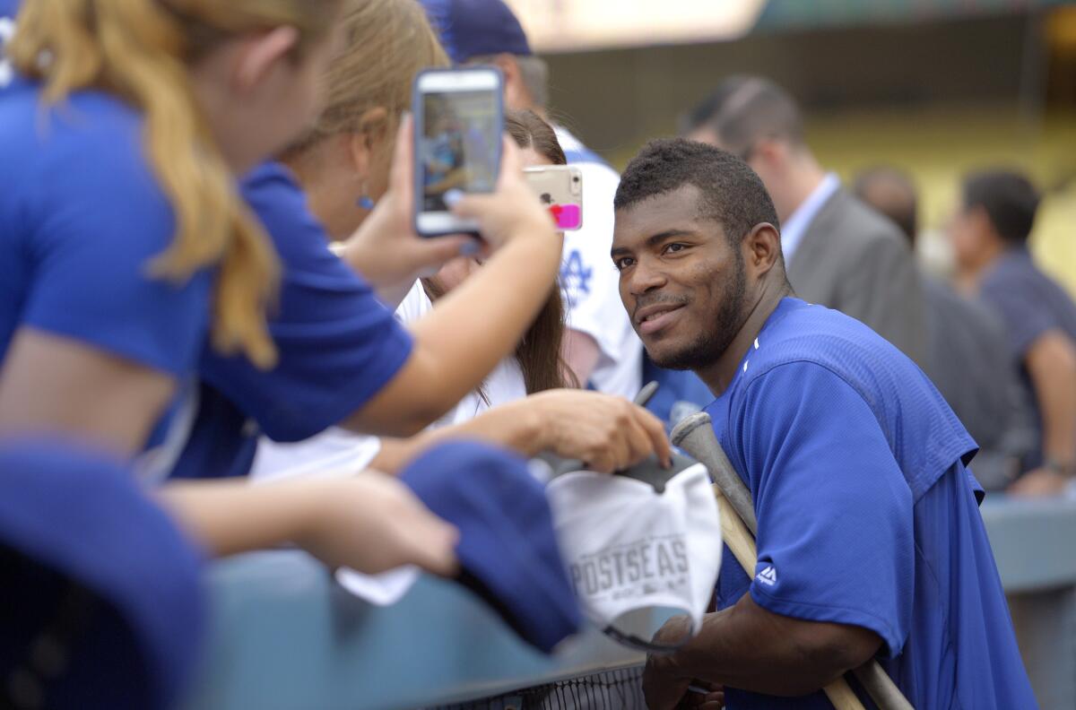 Yasiel Puig poses for photographs with fans before a game against the Arizona Diamondbacks on Sept. 21.