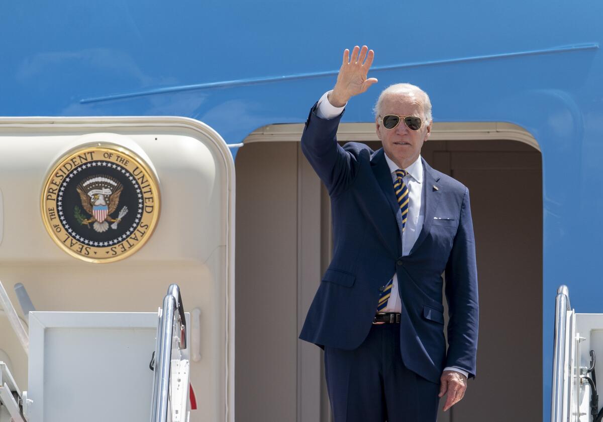 President Biden waves before boarding Air Force One