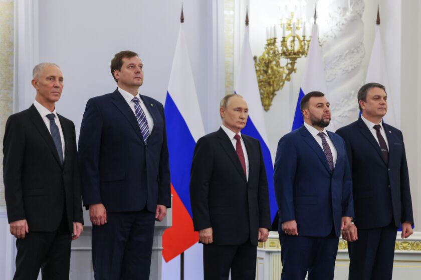 From left, Moscow-appointed head of Kherson Region Vladimir Saldo, Moscow-appointed head of Zaporizhzhia region Yevgeny Balitsky, Russian President Vladimir Putin, center, Denis Pushilin, the leader of the Donetsk People's Republic and Leonid Pasechnik, leader of self-proclaimed Luhansk People's Republic stand during a ceremony to sign the treaties for four regions of Ukraine to join Russia, at the Kremlin in Moscow, Friday, Sept. 30, 2022. The signing of the treaties making the four regions part of Russia follows the completion of the Kremlin-orchestrated "referendums." (Mikhail Metzel, Sputnik, Kremlin Pool Photo via AP)