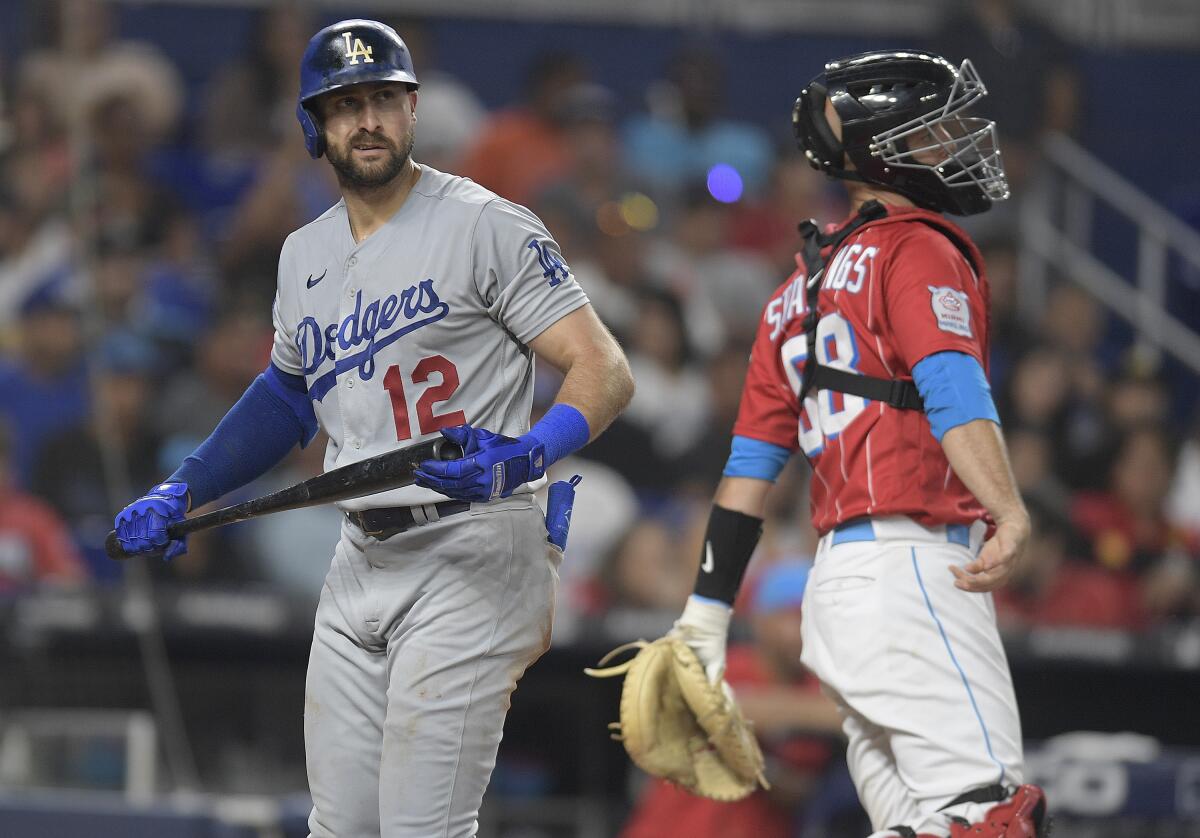 Los Angeles Dodgers Joey Gallo (12) walks past Miami Marlins catcher Jacob Stallings.