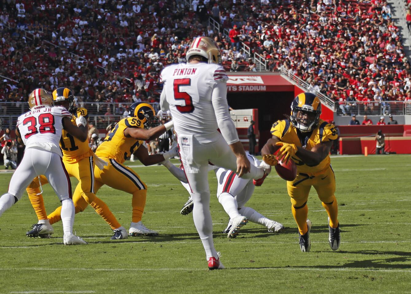 Rams linebacker Cory Littleton (58) blocks a punt by San Francisco 49ers punter Bradley Pinion (5) which led to a safety in the first half at Levi's Stadium on Sunday in Santa Clara.