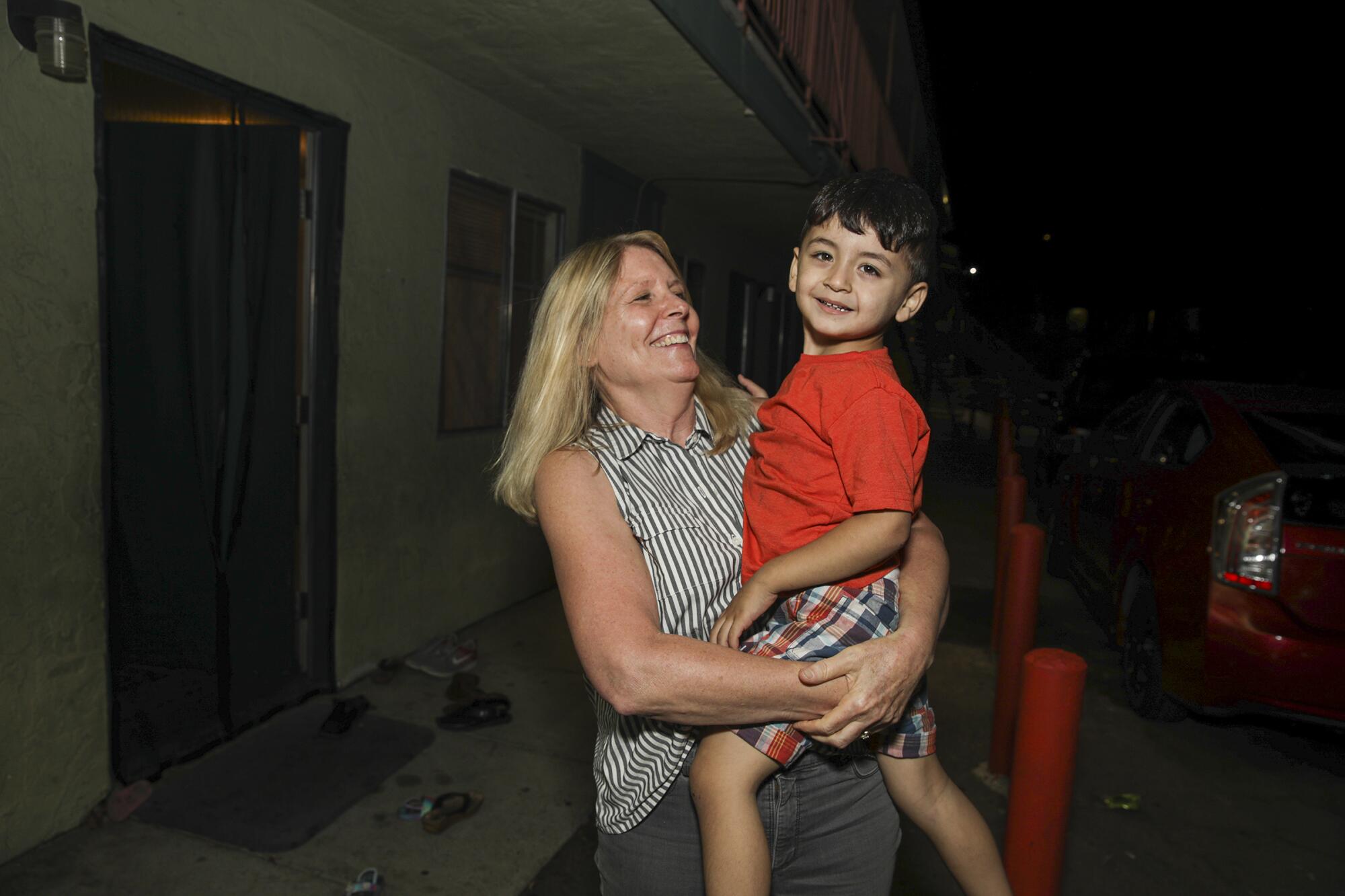 Nancy Harman holds 2-year-old Omar Khaliqyar