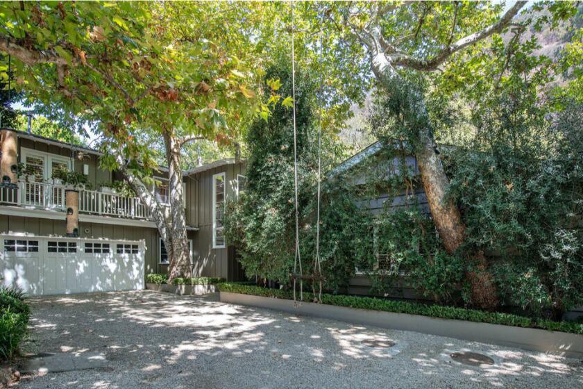 Surrounded by sycamore trees, the leafy residence centers on a five-bedroom traditional built in the 1950s.