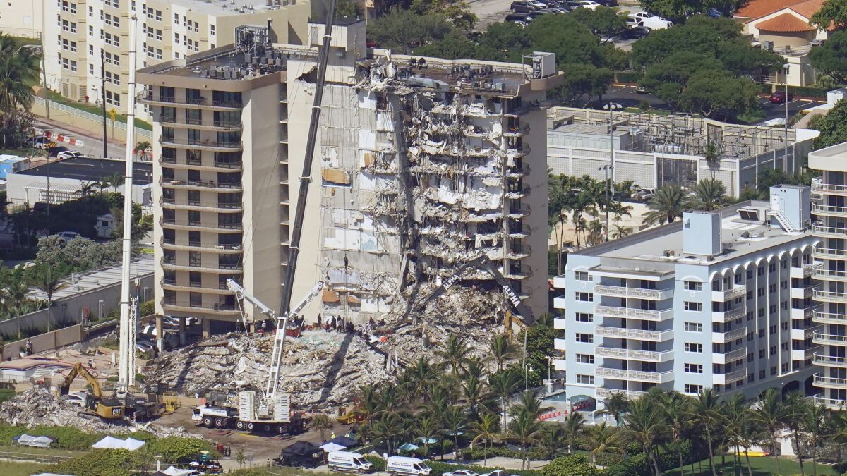 A view of the collapsed condo tower and rescue equipment.