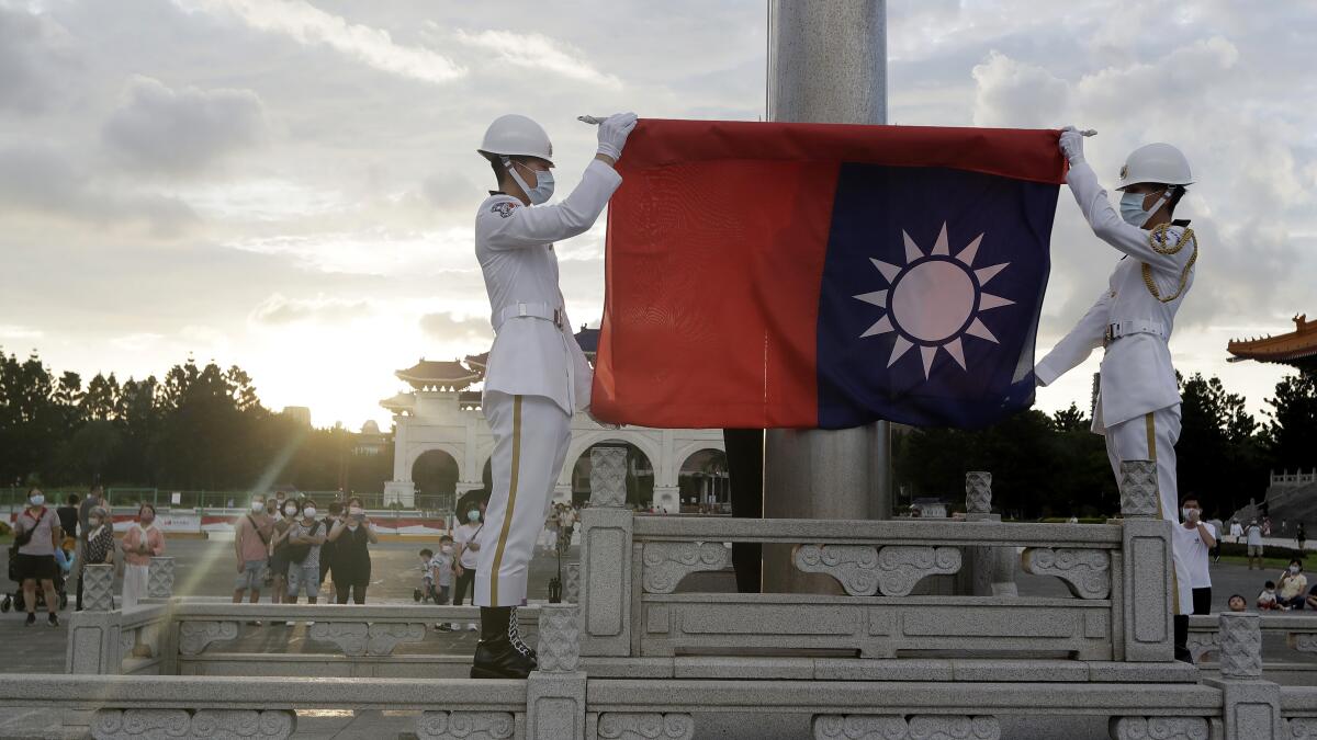 Taiwan cuts funding for flag-bearing Olympian who wore China uniform