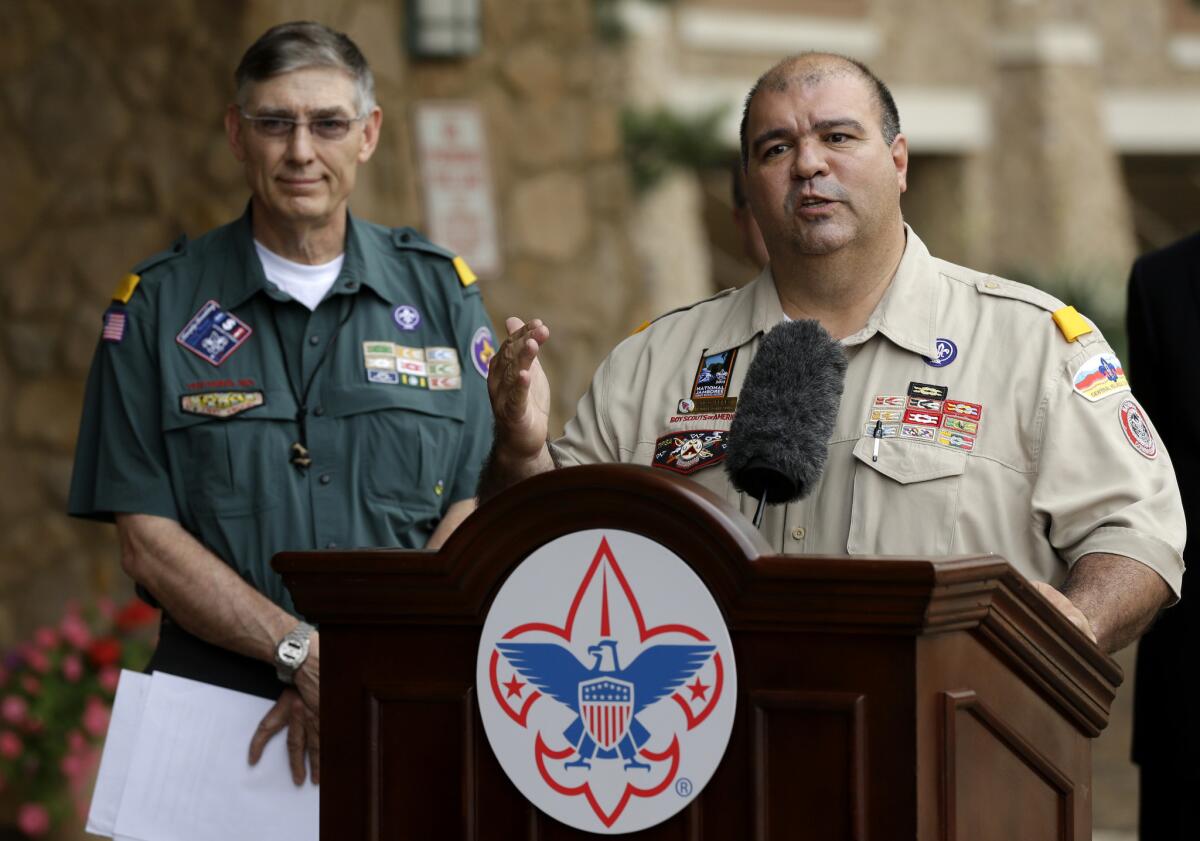 Boy Scouts of America National Commissioner Tico Perez, right, speaks to reporters in Grapevine, Texas, after the organization voted to allow openly gay youths to serve as Scouts. At left is Scouts' President Wayne Perry.