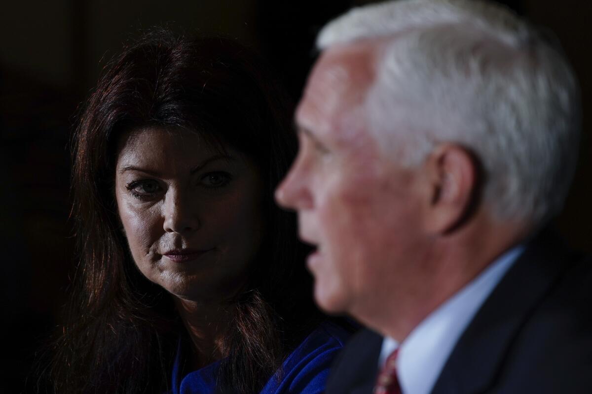 Wisconsin Rebublican gubernatorial candidate Rebecca Kleefisch listens to former Vice President Mike Pence at they participate in a round table discussion Wednesday, Aug. 3, 2022, in Pewaukee, Wis. (AP Photo/Morry Gash)