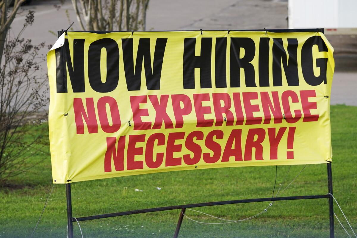 A roadside banner reads "Now Hiring No Experience Necessary!"