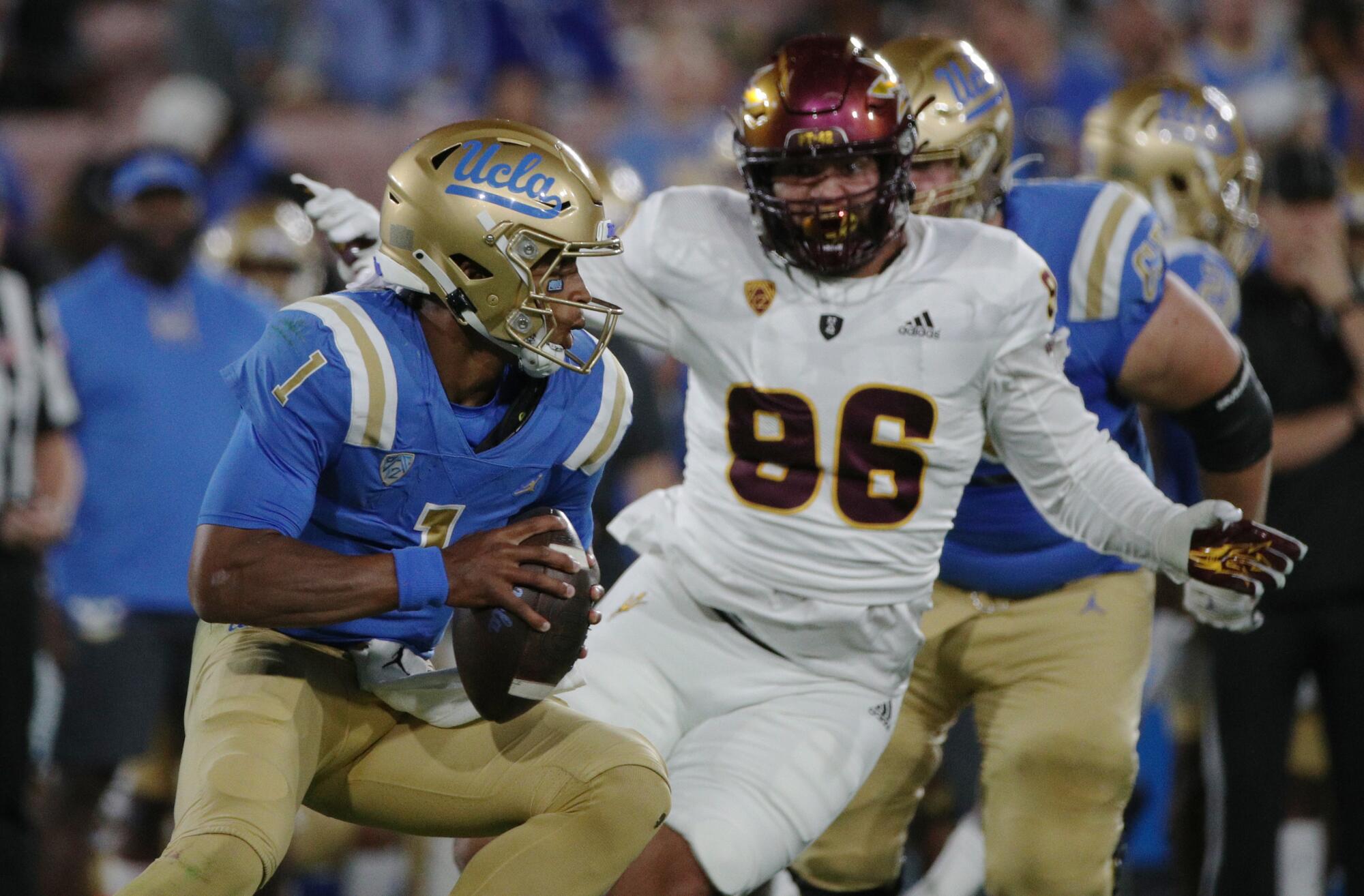 UCLA quarterback Dorian Thompson-Robinson scrambles out of the pocket in the first half against Arizona State.