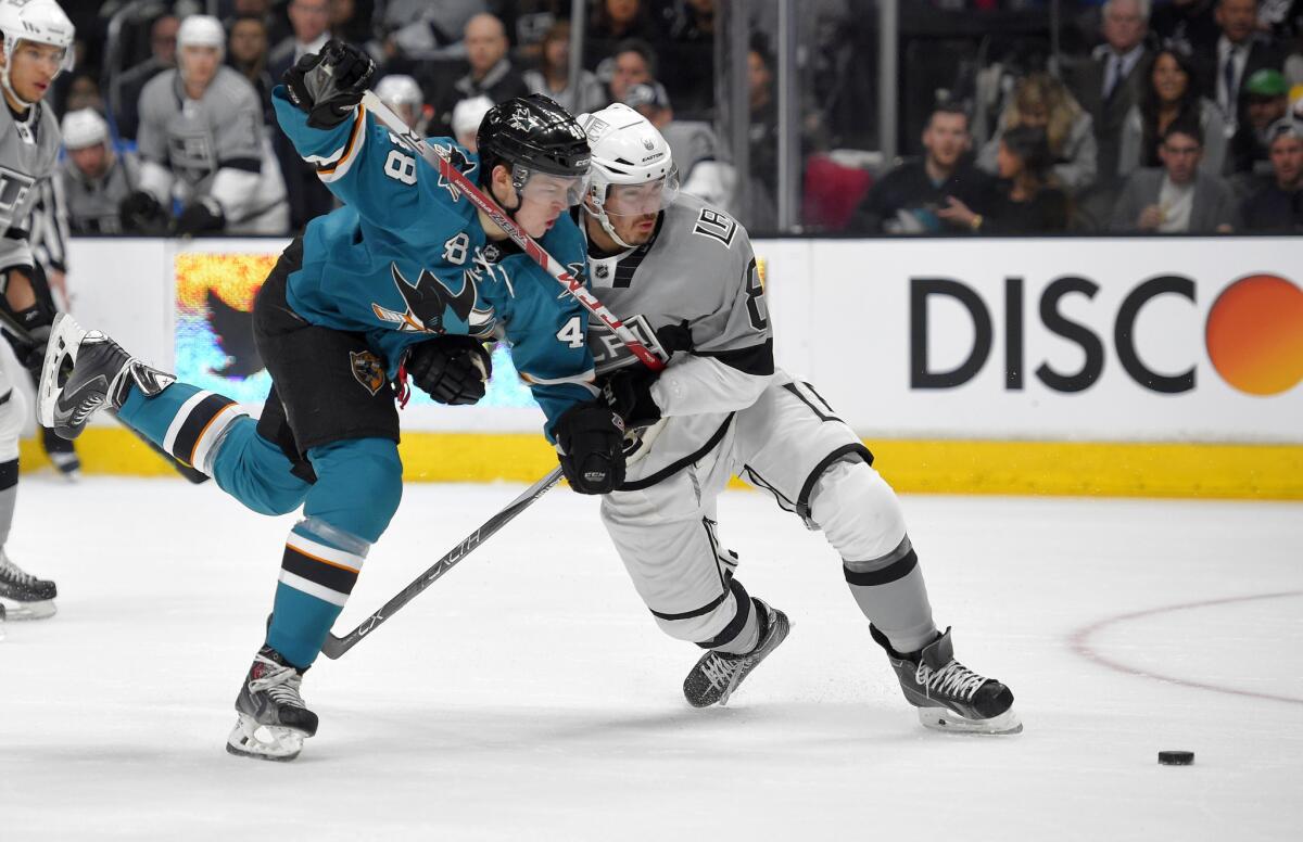 Kings defenseman Drew Doughty battles with San Jose center Tomas Hertl during the first period of a game on April 11.