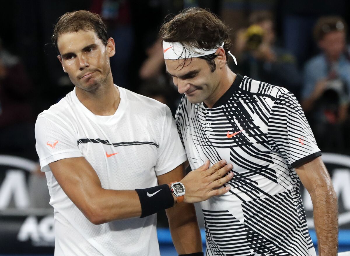 Switzerland's Roger Federer, right, and Spain's Rafael Nadal share a moment on the court.