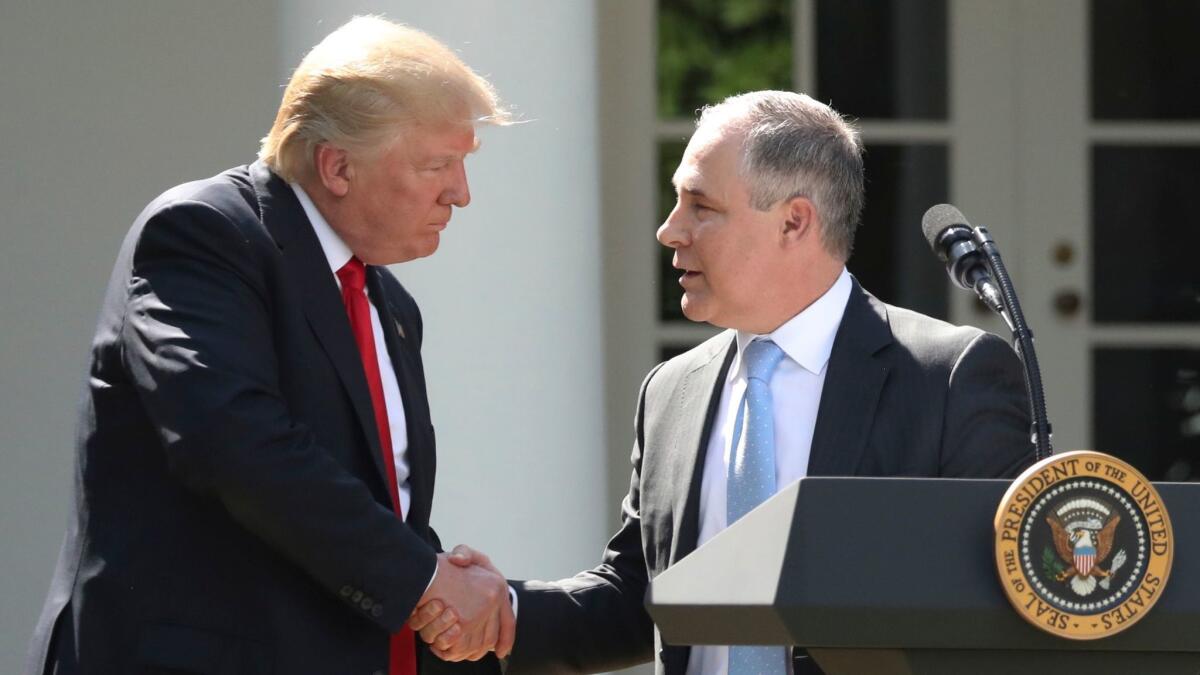 President Donald Trump shakes hands with EPA Administrator Scott Pruitt in the Rose Garden of the White House in Washington on June 1.