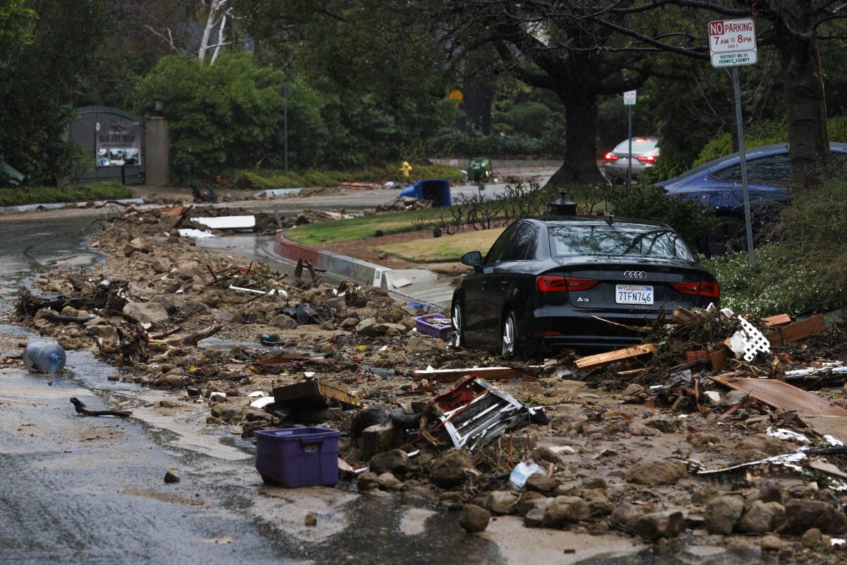 Debris lines the street in front of nine homes that were evacuated due to a landslide in Studio City.