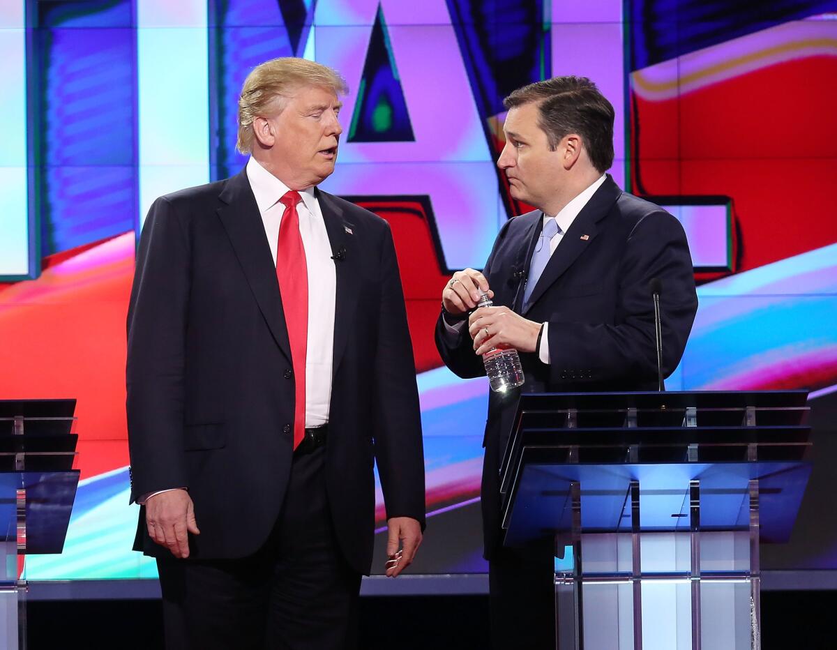 Republican presidential candidates Donald Trump and Sen. Ted Cruz talk during a broadcast break in the March 10 debate in Coral Gables, Fla.